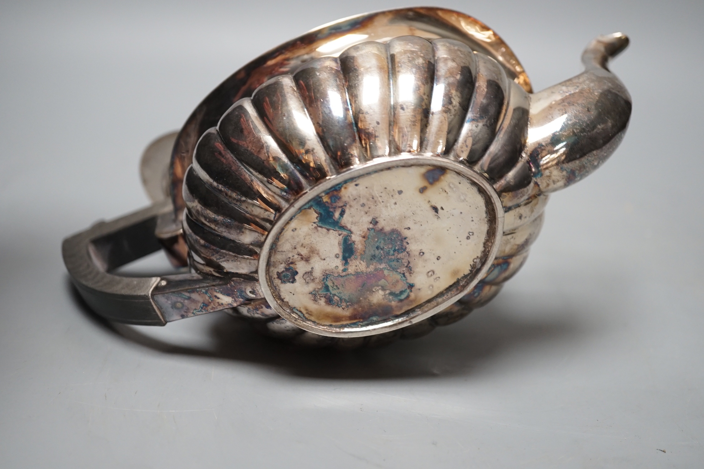 A late Victorian demi-fluted silver teapot, Chester, 1898, gross 10oz.